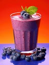 Blueberry smoothie in a glass on a red and blue background