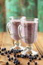 Blueberry smoothie in two glass Irish mugs and fresh forest blue