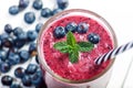 Blueberry smoothie on a wooden white background. Glass of smoothie with berry and mint. Fruit Healthy food. Breakfast. Royalty Free Stock Photo