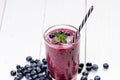 Blueberry smoothie on a wooden white background. Glass of smoothie with berry and mint. Fruit Healthy food. Breakfast. Royalty Free Stock Photo