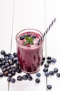 Blueberry smoothie on a wooden white background. Glass of smoothie with berry and mint. Fruit Healthy food. Breakfast. Royalty Free Stock Photo