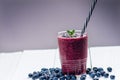 Blueberry smoothie on a wooden white background. Glass of smoothie with berry and mint. Fruit Healthy food. Breakfast. Royalty Free Stock Photo