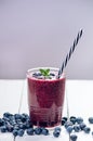 Blueberry smoothie on a wooden white background. Glass of smoothie with berry and mint. Fruit Healthy food. Breakfast. Royalty Free Stock Photo