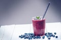 Blueberry smoothie on a wooden white background. Glass of smoothie with berry and mint. Fruit Healthy food. Breakfast. Royalty Free Stock Photo