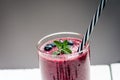 Blueberry smoothie on a wooden white background. Glass of smoothie with berry and mint. Fruit Healthy food. Breakfast. Royalty Free Stock Photo