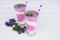 Blueberry smoothies fruit juices and blueberries on a white wooden backgroun. Drink in the morning for good health. Royalty Free Stock Photo