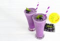 Blueberry smoothies, fruit juices and blueberries on a white wooden background. Drink in the morning for good health. Royalty Free Stock Photo