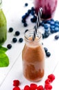 Blueberry, spinachy and orange smoothie on a wooden white background. Glasses of smoothie with berry and mint. Berry, leaf and lim Royalty Free Stock Photo