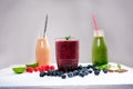 Blueberry, spinachy and orange smoothie on a wooden white background. Glasses of smoothie with berry and mint. Berry, leaf and lim Royalty Free Stock Photo