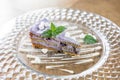 Blueberry sponge cake decorated with meringue and mint leaves. Breakfast in the cafe, morning coffee. on wooden table Royalty Free Stock Photo