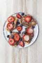 Blueberry and strawberry pancakes in a silver plate on a wooden table Royalty Free Stock Photo