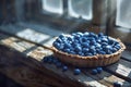 Blueberry tart on sunlit rustic table, brimming with fresh berries