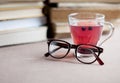 Blueberry tea in glass cap with eyeglasses