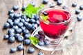 Blueberry tea with mint leaves on wooden background Royalty Free Stock Photo