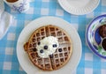 Blueberry waffle breakfast with powdered sugar and whipped cream Royalty Free Stock Photo