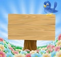 Bluebird sitting on wood sign with flowers
