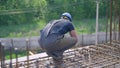 A bluecollar ironworker diligently constructs steel structures at a busy site