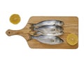 Bluefish and lemon slice on wooden hob with white background