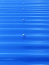 Blueish metallic corrugated sheet roof texture. Deep blue profiled sheet panel. Corrugated Metal Roof Exterior Close up