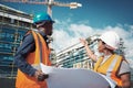 Blueprint, engineer or architect team talking outdoor about building project, construction or architecture. Black woman Royalty Free Stock Photo