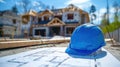 Blueprint and hard hat at house construction Royalty Free Stock Photo