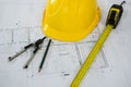 Blueprint with tape measure, pencil , thumbscrew compasses and hard hat Royalty Free Stock Photo