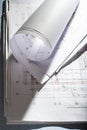 Blueprints on architect desk. Stacked and rolled up architectural projects on natural window light Royalty Free Stock Photo