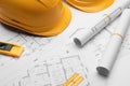 Blueprints, hardhats, level and ruler on white table Royalty Free Stock Photo