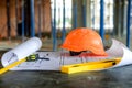 Blueprints project building, construction level and helmet, close up. Construction concept Royalty Free Stock Photo
