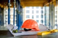 Blueprints project building, construction level and helmet, close up. Construction concept Royalty Free Stock Photo