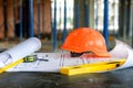 Blueprints project building, construction level and helmet, close up. Construction concept Royalty Free Stock Photo