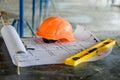 Blueprints project building, construction level and helmet, close up. Construction concept Royalty Free Stock Photo