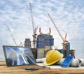 Blueprints and safety helmet in construction site