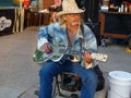 Blues artist playing an acoustic guitar at the Dane County Farmer`s Market in Madison, WI