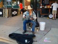 Blues artist playing an acoustic guitar at the Dane County Farmer`s Market in Madison, WI