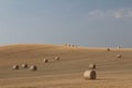 Field with round hay bales with blue sky and clouds on a summers evening in UK Royalty Free Stock Photo