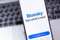 Bluesky Social logo mobile app on a screen smartphone iPhone. Bluesky Social - Twitter alternative Bluesky hits the App Store as