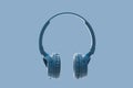 Bluetooth blue headphone on blue background Royalty Free Stock Photo