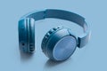 Bluetooth blue headphone on blue background