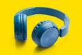 Bluetooth blue headphone on yellow