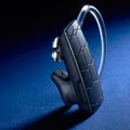 Bluetooth Headset on blue background Royalty Free Stock Photo