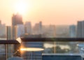 Blur abstract background city morning gold light sky rooftop view over cityscape with bright sun flare and bokeh