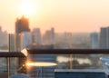 Blur abstract background city morning gold light sky rooftop view over cityscape with bright sun flare and bokeh