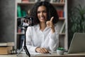 Blur background of african american woman in white shirt recording new video blog Royalty Free Stock Photo