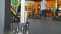 Blur background. barbells in the gym. Blurred fitness room with weight training bar