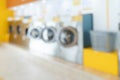 Blur background of qualified coin-operated washing machines in a public store. Royalty Free Stock Photo