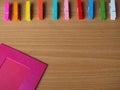 Row of colorful wooden pegs with pink picture frame on wooden table Royalty Free Stock Photo
