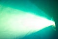 Blur beautiful green color wide lens projector with light beam . smoke texture spotlight Royalty Free Stock Photo