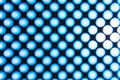 Blur blue abstract background on based of metal, circles and shadows, texture of the white surface with a lot of round holes Royalty Free Stock Photo