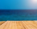 The blur blue sea background with wood floor foreground, relaxing outdoors vacation with paradise view at a resort deck touching Royalty Free Stock Photo